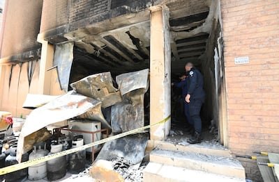 Kuwaiti security forces inspect the building where the fire broke out in Mangaf. EPA