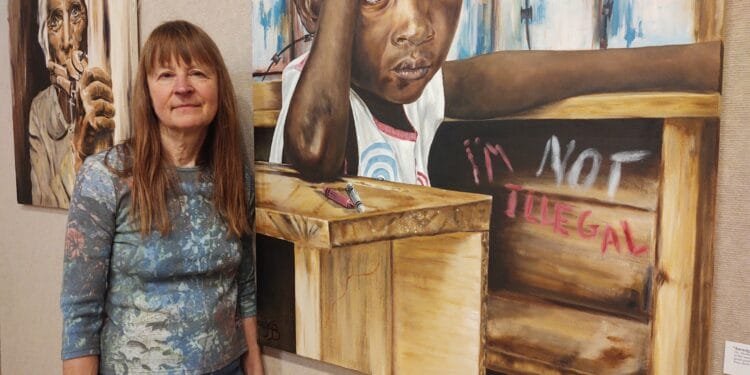 An artist paints portraits of refugees and immigrants