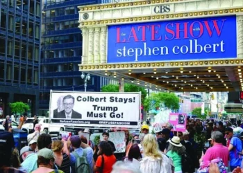 protesters hold placards supporting colbert photo afp
