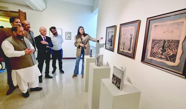 federal culture minister aurangzeb khichi and others admire art pieces on display at the shared distances exhibition at the pnca in islamabad photos app
