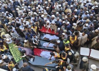 Pakistanis mourn 18 people killed in suicide bombing at an army base