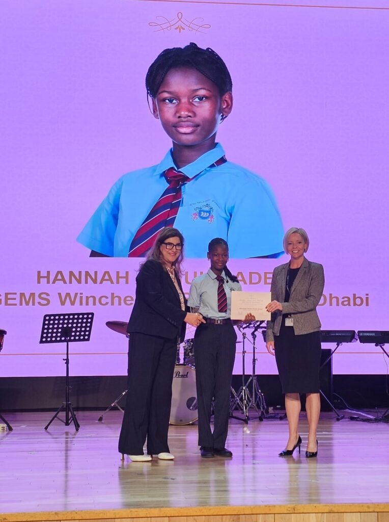 Ranju Anand Executive Vice President at GEMS Education giving Sheikha Fatima Bint Mubarak Award for Excellence to Ebunoluwa Hannah Atinuke Adelani