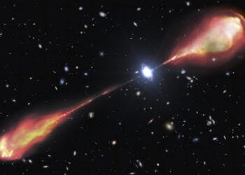 Telescopes spy a monster radio jet streaming from a bright and early object in the universe