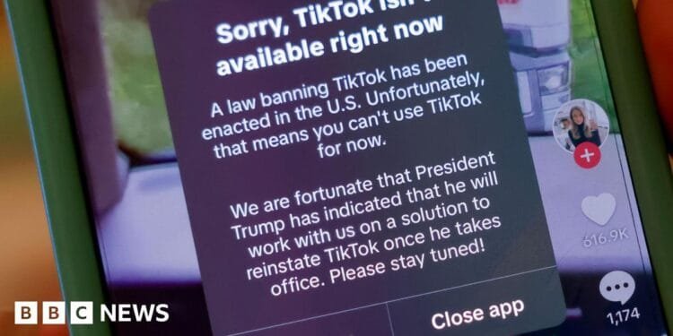 Young man and old woman hold sunflowers