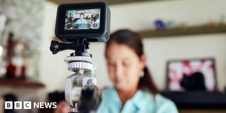 Prince Harry walks through an outdoor green space, wearing a suit and tie, while looking away from camera, taken in Johannesburg in October.