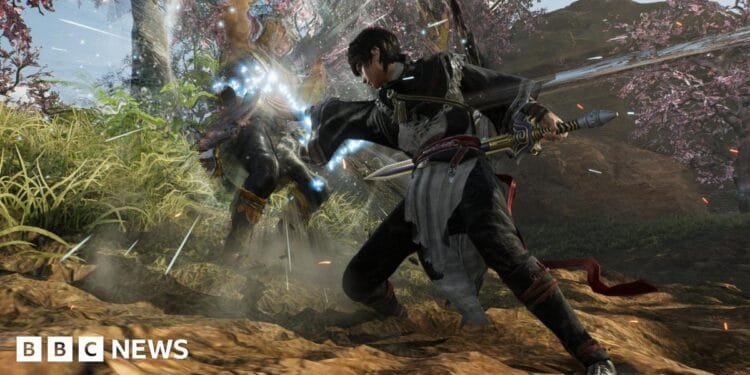 A character attacks another, causing him to fly backwards with light refracting off his body. They are both dressed in feudal era Chinese clothes and wielding swords. Behind them, a lush green scene with cherry blossom trees.