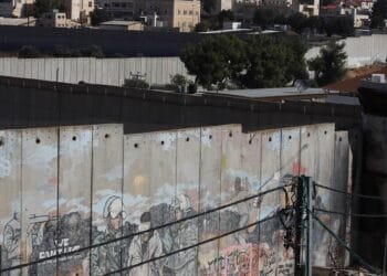 ‘I lost both legs’: Palestinians scale separation wall for chance to work