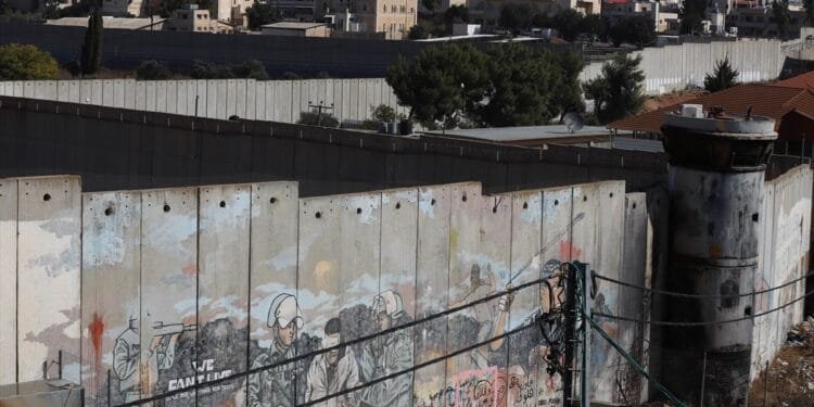 ‘I lost both legs’: Palestinians scale separation wall for chance to work